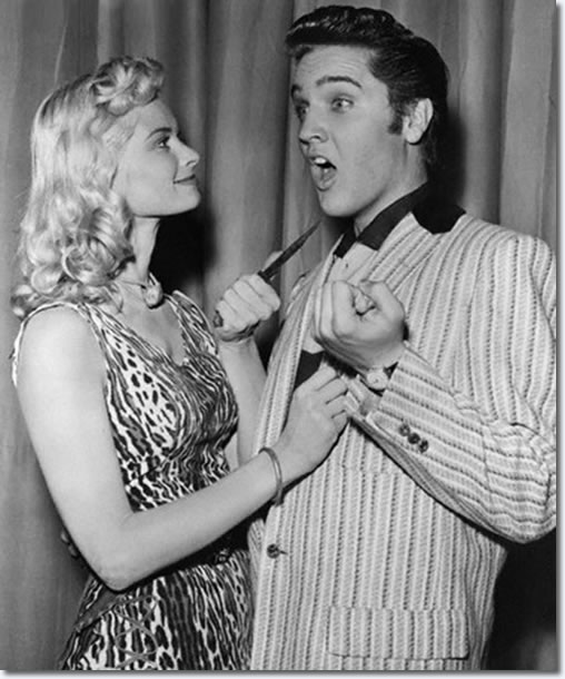 Irish McCalla the exotic looking star the of TV series 'Sheenah Queen Of The Jungle' jokes with Elvis Presley backstage.