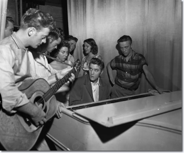 Elvis Presley back stage at the piano : Jacksonville : August, 1956 : Note Red West at left.