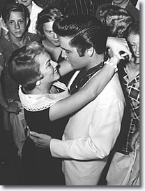 Making no secret of their affection for each other, Elvis and Anita Wood look into each others eyes like any other lovers bidding farewell