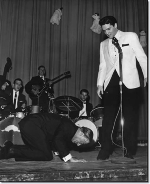 Comedian George Jessel hit the stage in an exaggerated salaam to the King of rock and roll.