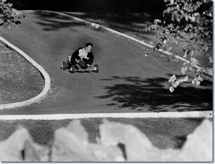 Elvis Presley on a go cart racing up the driveway of Graceland : October 12, 1965