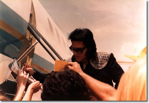 Elvis Presley at the airport in Oklahoma City, where Elvis had entertained over 15,000 fans the night before the Myriad Convention Center. Now they were on their way to Terra Haute, Indiana.