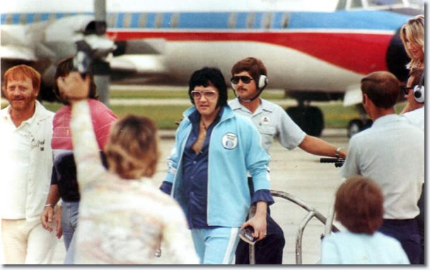 Elvis Presley departing the Lisa Marie with Linda Thompson in Shreveport on July 1, 1976 (also in the photos are Red and Sonny West, Rick Stanley, Lamar Fike and Charlie Hodge)