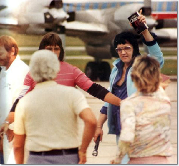Elvis Presley departing the Lisa Marie with Linda Thompson in Shreveport on July 1, 1976 (also in the photo is Sonny West)