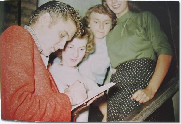 Elvis signs autographs for some female admirers in Cleveland, October 19, 1955.