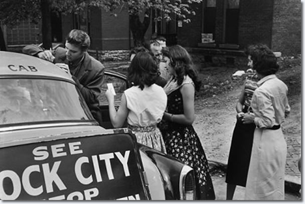 Elvis signing autographs for fans as he leaves the studio - April 14, 1956