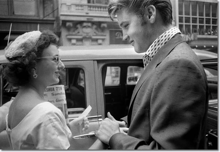 Having arrived at the Hudson Theater in New York City to perform on the Steve Allen comedy show, Elvis is greeted by a female fan who had come all the way in from Long Island to meet her idol. (New York City, July 1, 1956) 