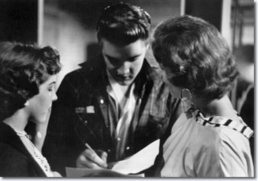 Elvis signing autographs between shows in the fieldhouse - May 27, 1956