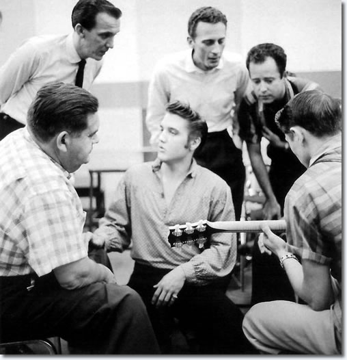 L-R Steve Sholes sat foreground, Hugh Jarrett stood behind him, Elvis centre, with Hoyt Hawkins and Gordon Stoker look over to Scotty Moore on the right of frame with his 1954 L5 CESN.