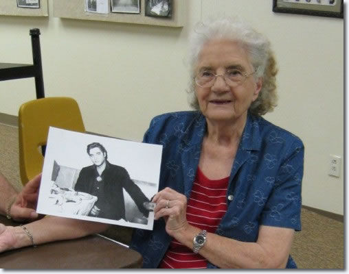 Aline Landrum with a photo of Elvis Presley taken September 12, 1957.