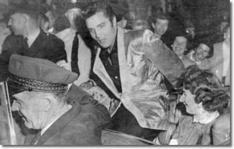 George Corrie (chauffeur) drives Elvis and fan club contest winner around Empire Stadium prior to start of the show