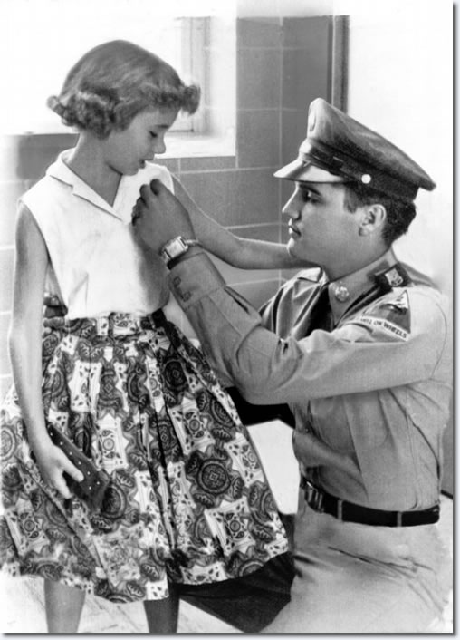 Elvis Presley admires a pin worn by 9-year-old Judy McCreight during August 1958. They were both at Methodist Hospital visiting family members who happened to be on the same floor. Elvis was on leave from Fort Hood, Texas, visiting his mother and Judy was visiting family members who had been in an accident.