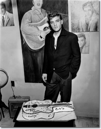 Elvis Presley, dressed in civilian clothes, posed with a cake sent by an anonymous fan for his Army homecoming. Elvis was greeted by a crowd of some 200 people in the early morning cold at Memphis's Union Station March 7,1960. In the afternoon, he held a press conference in the two room office building behind Graceland where his 1957 Christmas (his last xmas at home) tree still stood. He arrived in Memphis by private rail car pulled by Southern Railway's Tennessean about 7:45 a.m. He was officially discharged the previous Saturday (March 5) at Ft. Dix, N.J.