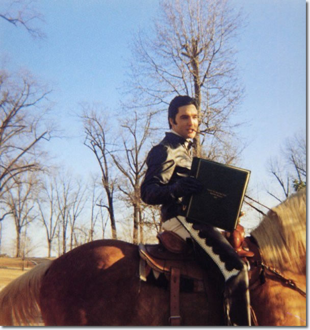 Elvis Presley : Horseback riding at Graceland : February 9, 1968. Elvis is holding a gift from the Australian Fan Club.