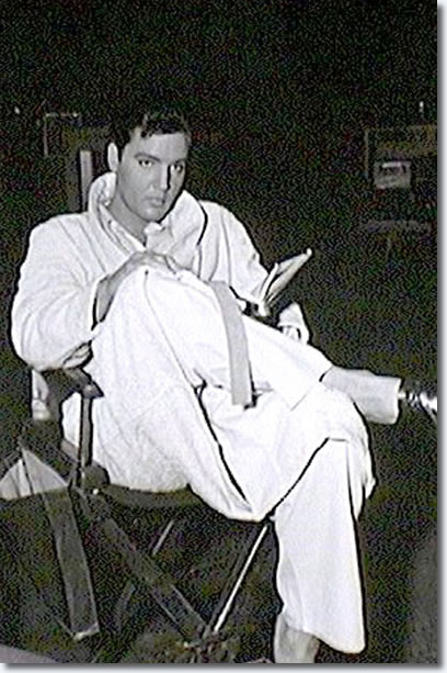 Elvis in his robe relaxing and reading in between scenes of Fun in Acapulco