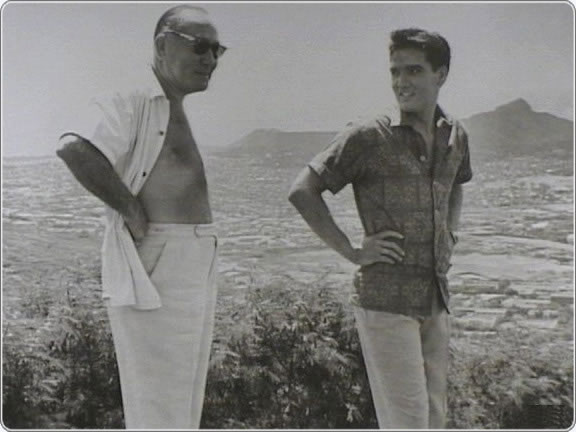 Elvis and Director Hal Wallis take some time to relax during the filming of Blue Hawaii on location in Hawaii in 1961.