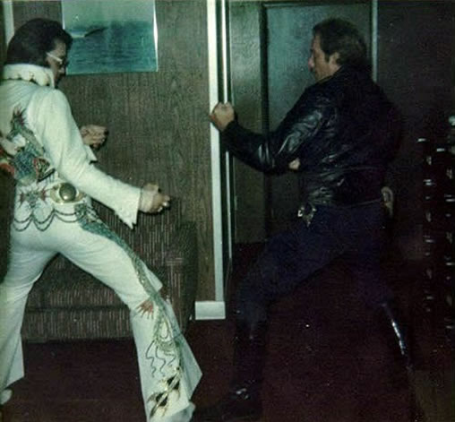 Elvis Presley : Detroit : Friday, October 4, 1974, karate pss with police officer.