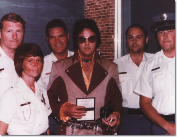 Elvis Presley with local police before boading his plane to leave Greensboro for Asheville, North Carolina.