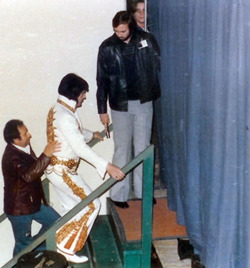 Joe Esposito, Sam Thompson and David Stanley with Elvis as he hits the stage in Charlotte, NC on February 20, 1977.
