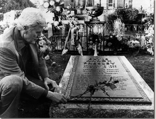 Vernon Presley, Elvis Presley's father, places a rose on his son's grave Nov. 24, 1977, as newspeople were permitted inside the grounds at Graceland in Memphis, Tenn., for the first time since Elvis' funeral.