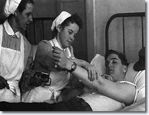 With other soldiers, Elvis donates blood at the Wartturm Barracks in Friedberg for the German Red Cross.